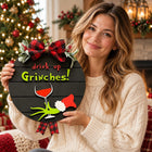 Drink Up Grinches Door Sign — Held by a model