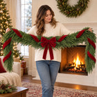 Norfolk Pine Garland with Red Velvet Bows — Held by a model
